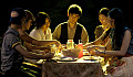 a group of people sitting around a table sharing a meal